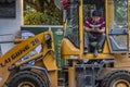 Worker sitting on an excavator