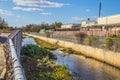 A canal in an industrial area overgrown