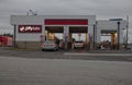 Cars in line at Jiffy Lube on a cloudy day