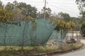 Chain link fence green tarp cover overgrown grunge dirty Royalty Free Stock Photo