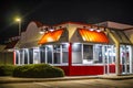 A closed Krystal Burgers restaurant at night corner view