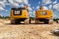 Construction site pair of CAT front loaders back view