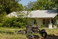 Discarded pile of car tires in a lot by a house