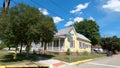 Downtown scenes pan of beautiful colorful historic yellow wooden home Royalty Free Stock Photo