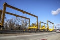 Huge Heavy industrial road machines and cranes on a bridge construction site top copyspcae yellow structure