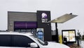 New Taco Bell restaurant exterior car passing by Royalty Free Stock Photo