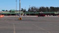 Pan of a empty Covid-19 vaccine clinic in a strip mall set up with orange cones and parking lot