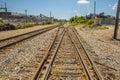 Railroad tracks through an industrial area center view Royalty Free Stock Photo