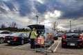 Senior putting groceries in her car wearing a face mask