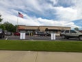 Street pan of Chick Fil A restaurant and parked catering van lines at the drive thru