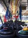 AULLA, ITALY- February 12 2020: Rows of Dodgem aka Bumper Cars parked up in Fun Fair Amusement Park. With Italian flag.