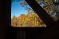 Auntumn colors view through structural detail of Sunday River historic covered bridge