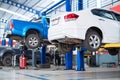 Auomobile repair, Car service centre auto repair with wehicle raised on lift workshop. Car repair service center Royalty Free Stock Photo