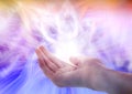 Aura phenomena. Woman with flows of energy around her hand against color background, closeup Royalty Free Stock Photo