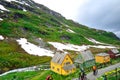 AURLAND, NORWAY: Bikers walking their bicycles through a small lane next to the beautiful green mountain in Aurland,