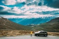 Aurlandsfjellet, Norway. Young Woman Tourist Traveler Photographer Taking Pictures Photos Near Parked Renault Duster Car