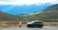 Aurlandsfjellet, Norway. Young Woman Tourist Traveler Photographer Taking Pictures Photos Near Parked Car Royalty Free Stock Photo