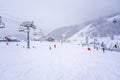Auron, France - 01.01.2021: Downhill skiing during a heavy snowfall. Professional ski instructors and children on a resort slope