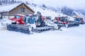 AURON, FRANCE - 02.01.2021: Snow plow trucks under the snow on a parking in the ski resort mountains.