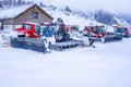 AURON, FRANCE - 02.01.2021: Snow plow trucks under the snow on a parking in the ski resort mountains.