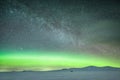 Aurora below a starlit sky