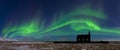 Aurora borealis above the church in Iceland. Green northern lights. Starry sky with polar lights. Royalty Free Stock Photo