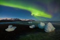 Aurora borealis above the sea. Jokulsarlon glacier lagoon, Iceland. Green northern lights. Starry sky with polar lights. Royalty Free Stock Photo