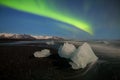 Aurora borealis above the sea. Jokulsarlon glacier lagoon, Iceland. Green northern lights. Starry sky with polar lights. Royalty Free Stock Photo