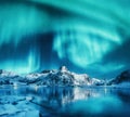 Aurora borealis above snowy mountains, frozen sea coast Royalty Free Stock Photo