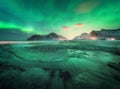 Aurora borealis above the snowy mountains and sandy beach Royalty Free Stock Photo