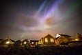 Aurora borealis above village, Lofoten islands, Norway