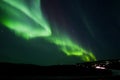 Aurora Borealis arc over hill terrain Royalty Free Stock Photo