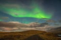 Aurora Borealis in Iceland northern lights bright beams rising in green beams over hiking path Royalty Free Stock Photo