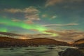 Aurora Borealis in Iceland northern lights bright beams rising in green beams reflecting in river Royalty Free Stock Photo