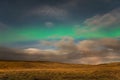 Aurora Borealis in Iceland northern lights shining green in night sky beyond the asterisk Big Dipper Royalty Free Stock Photo