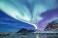 Aurora borealis on the Lofoten islands, Norway. Green northern lights above mountains.