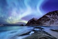 Aurora borealis on the Lofoten islands, Norway. Green northern lights above mountains. Night sky with polar lights. Royalty Free Stock Photo