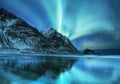 Aurora borealis on the Lofoten islands, Norway. Green northern lights above mountains. Night sky with polar lights. Royalty Free Stock Photo