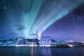 Aurora borealis on the Lofoten islands, Norway. Green northern lights above mountains. Night sky with polar lights. Night winter l