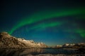 Aurora borealis on the Lofoten islands, Norway. Green northern lights above mountains. Night sky with polar lights. Night winter Royalty Free Stock Photo