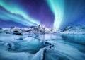 Aurora Borealis, Lofoten islands, Norway. Nothen light, mountains and frozen ocean. Winter landscape at the night time. Royalty Free Stock Photo