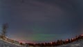 Aurora borealis in night northern sky. Ionisation of air particles in the upper atmosphere.