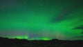 Aurora borealis in night northern sky. Ionisation of air particles in the upper atmosphere.