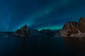 Aurora borealis or North light over Olstind mountain in Hamnoy village, Lofoten island in Norway, Scandinavia