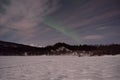 Aurora borealis, northern light over winter river landscape at night Royalty Free Stock Photo