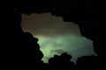 Aurora Borealis (Northern Lights) above a cave entrance Royalty Free Stock Photo