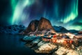 Aurora borealis, Northern lights over mountain with fishing village on coastline at Hamnoy, Lofoten islands Royalty Free Stock Photo