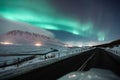 Aurora borealis, northern lights over the road, dancing queen on the clear sky during winter, Iceland