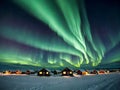 Aurora borealis over houses in winter Royalty Free Stock Photo