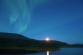 Aurora Borealis over the northern lake, early summer morning. Yamal, Russia